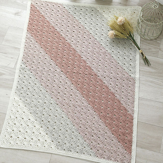 Full view of the rectangular blanket with diagonal gradient stripes.