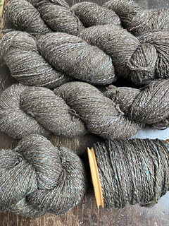 top skeins are first batch with lighter silk, bottom skein and bobbin have brighter silk.