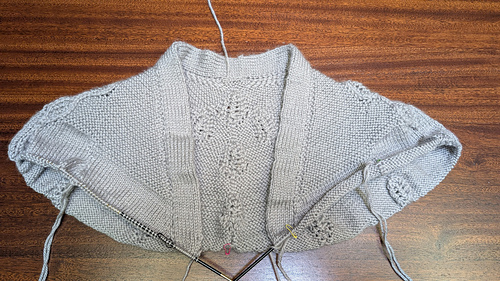 An elegant v-neck integrated buttonband worked as you go. Game changer!