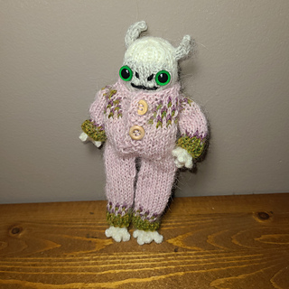 Frostling and outfit both knit using Drop's Alpaca and US 2 needles