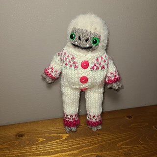 Yeti is knit with Lionbrand feels like bliss, and US 4 needles. Outfit is Paintbox Simply dk and US 2 needles 