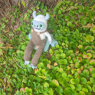 Yeti wearing the included overalls pattern. Beret not pictured here