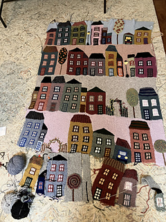 12/20: comparing with previous photo, you can see how I was able to switch rows and rearrange buildings by not sewing them together and not adding sky till the end.