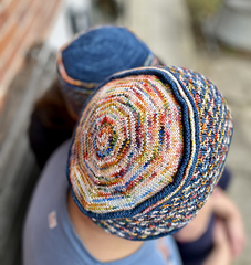 Her Cassaluna Cap follows the original pattern version.
He chose to reverse the main and contrast colors (MC & CC) for his sample.