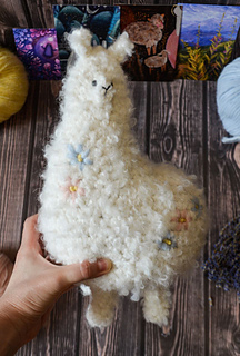 Big crochet soft toy - white plush alpaca with floral embroidery made of boucle yarn pdf pattern