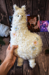 Big crochet soft toy - white plush alpaca with floral embroidery made of boucle yarn pdf pattern