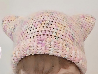 A crocheted cat ear beanie with a ribbed edge