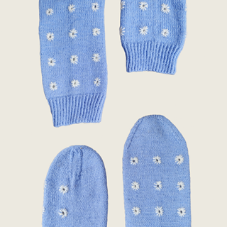 The toes and cuffs of the blue socks with white eyelet embroidery.