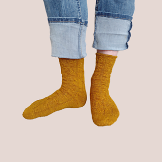The same mustard-gold socks, feet turned out.