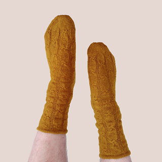 The same mustard-gold socks on feet pointed in the air.