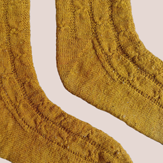 CLose up showing Fleegle-heel of mustard-gold socks.