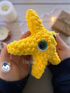 Crochet amigurumi pattern of a yellow Christmas star made with velvet yarn and big glittery eyes.