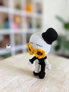 Handmade Art the Clown amigurumi inspired by Terrifier, featuring the iconic black-and-white costume, creepy facial details, and sunflower accessory in a detailed PDF crochet pattern for horror movie and amigurumi fans.