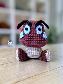 Handmade Goomba amigurumi inspired by Super Mario. Cute crochet Goomba with detailed eyes and eyebrows, PDF crochet pattern for Nintendo fans and amigurumi lovers.