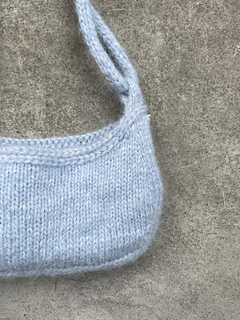 Increases, decreases and short rows that shape the bag.