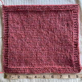 Width before blocking, knit on 4.5mm and 5mm needles (smaller size for purl rows): ~ 9.25 inches