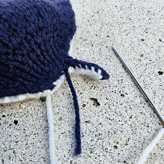 Sewing up the knitted manta ray mouth pieces