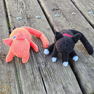 Two cute knitted cats on bench