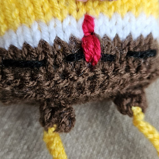 Knitted spongebob sewing a tie and belt