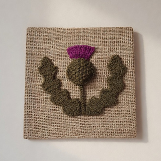 Knitted thistle picture on hessian