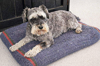 A structured knitted cover for rectangular pet bed inserts, worked as a continuous piece with textured panels and zipper closure for easy removal.