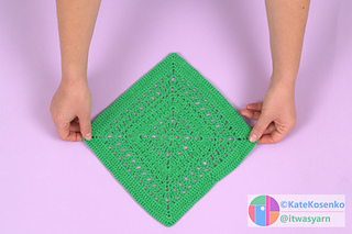 The wrong side of the green crocheted "March" square, displayed on a light surface.