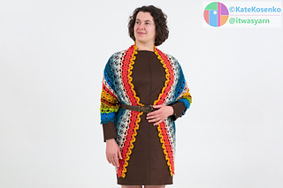 Front view of crochet shawl draped over shoulders with ends hanging in front, styled with belt and soft stripes