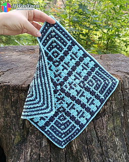 Hand holding the corner of the Pulse overlay mosaic crochet square.