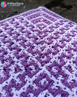 A corner of Drift crochet square in purple and lavender colors.