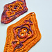 Close-up photo of crochet patches with an intricate textured pattern of sports weight yarn