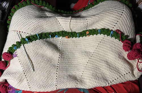 2025-06-18 only ten more roses to make! Crochet hook indicates where the leaves between roses will be only two, instead of three.