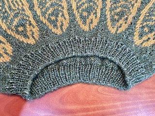 The yarn had bits of undyed fiber that pulls out even before the sweater has been worn.