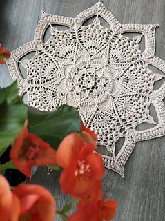 crochet doily, showcasing its intricate 9-pointed star design and delicate threadwork