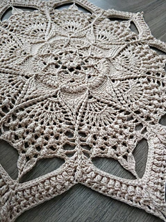 Arabesque crochet doily illustrating the size of the finished piece