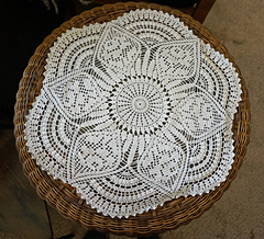 On a glass side table.  In places the edges look curved but they just drape down over the center glass section of the table.