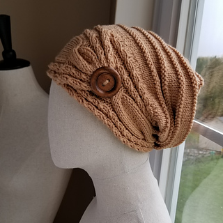 Ravelry: Button Tab Cable Brim Slouch Hat pattern by Rebecca Shalhoub