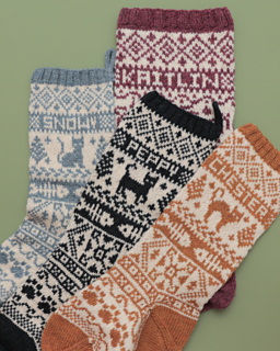 Sam customized her cat stockings using a DK weight yarn, 3.5mm (US 4) needles, and a mix of charts from various sources.