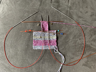 Circular needles were used to insert into the side stitches for the pick ups.  I knit them off the circulars.