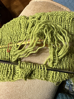 Well ^&*)#&( !!!!  I worked the cables the wrong way.  I unravelled one more row after this photo.  Using two DPNs to re-knit the mess worked a charm