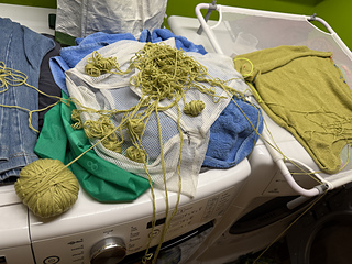 Washing and drying the sweater and yarn before finishing to be sure it would be long enough was a really good idea,  Thinking the yarn ball would be OK inside th laundry bag, not so much.  USE a YARN SOCK (or a regular sock or anything).  See notes for details. 