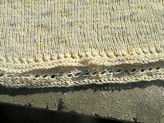 Image Description: a close up of the eyelet edging of a skirt knit in stocking stitch