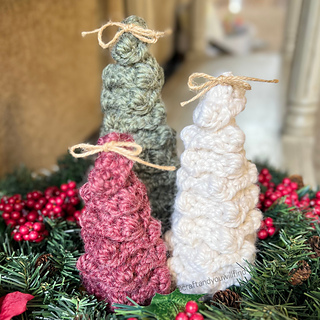 The Evergreen Holiday Trees crochet pattern comes in three size options with minimal twine bow styling.