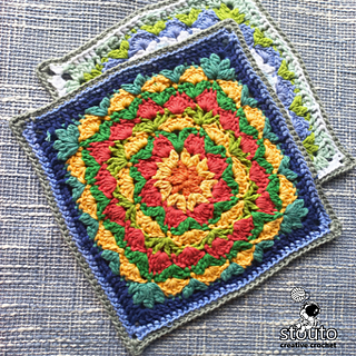 Crochet granny square with a floral center and structured corners, worked using cluster stitches and chain spaces.
