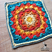 Textured dahlia flower granny square crocheted in the round, showing layered petals and a square frame.
