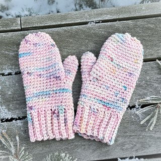 Crochet mittens in yarnicorn yarn from we are knitters on wood