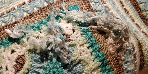 This is what the mouse left behind. A bunch of fuzzy, chewed up yarn. (It looked even worse before washing).