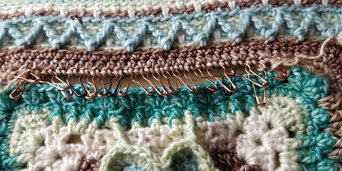 Last row to redo! Make a stitch, pull the loop through the stitch above, make another stitch... repeat.