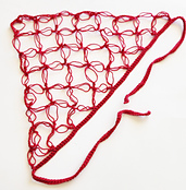 A beautifully crafted crochet triangle head scarf laid flat