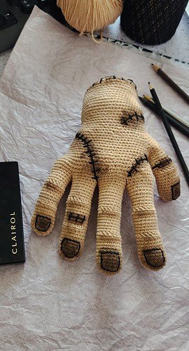 Close-up of the Anatomical Hand Thing, showing the detailed stitches, embroidered nails, and weathering effects.
