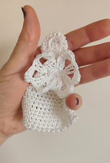 rocheted Healing Angel plushie held in comforting hands, offering a tangible symbol of love and empathy for those facing health challenges.
